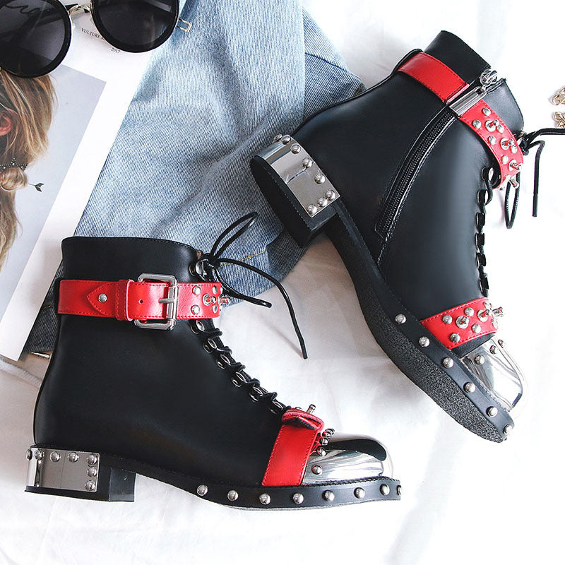 Black high-heeled boots with red straps and silver buckles on a white background