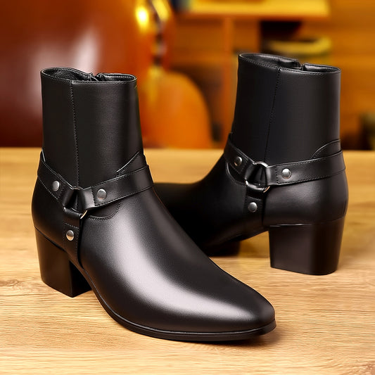 Pair of black leather boots with buckles on a wooden surface