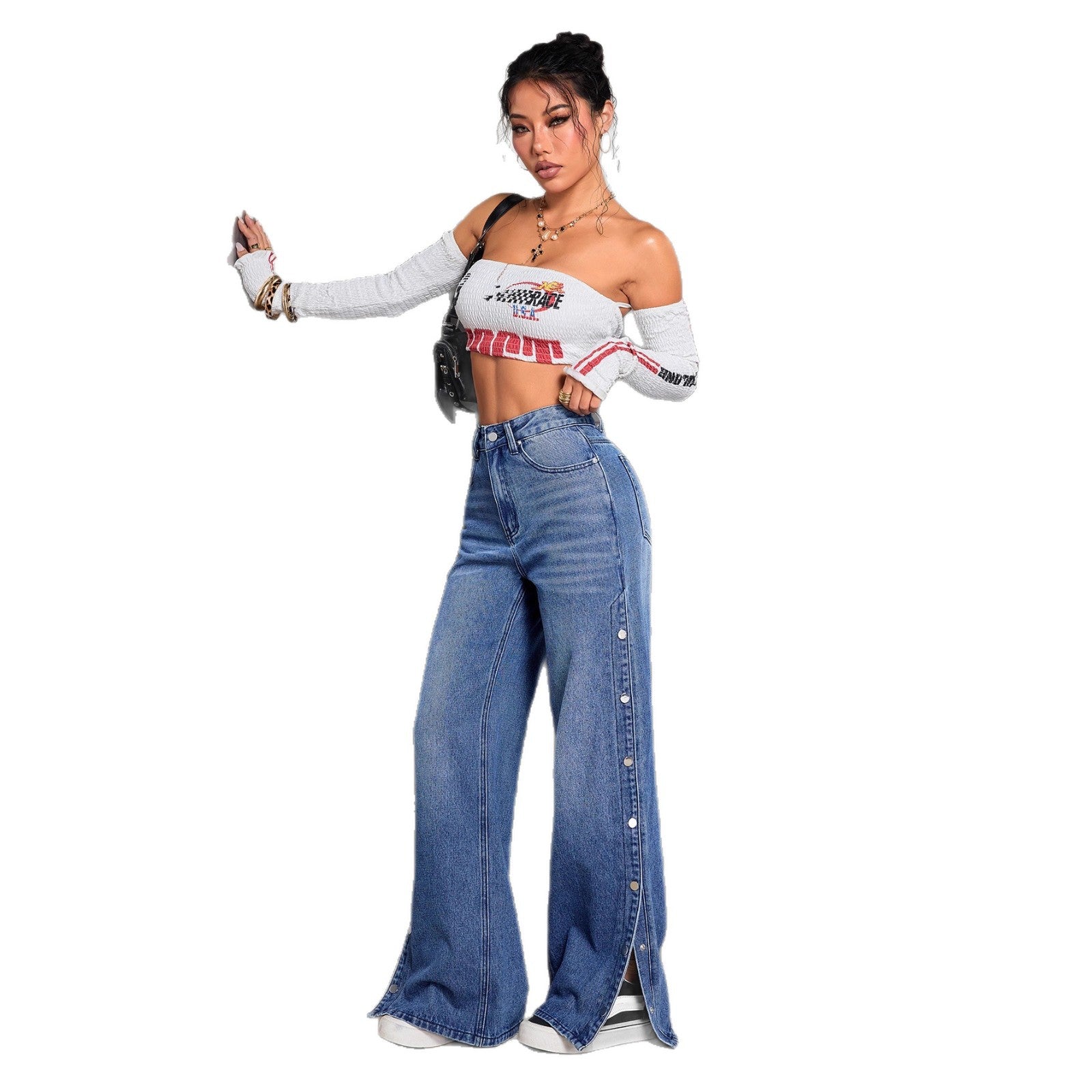 Woman wearing a white crop top with red text and high-waisted blue jeans on a white background