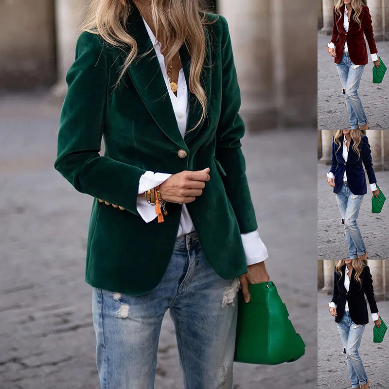Person wearing a green blazer, white shirt, and jeans with green shoes on a street.