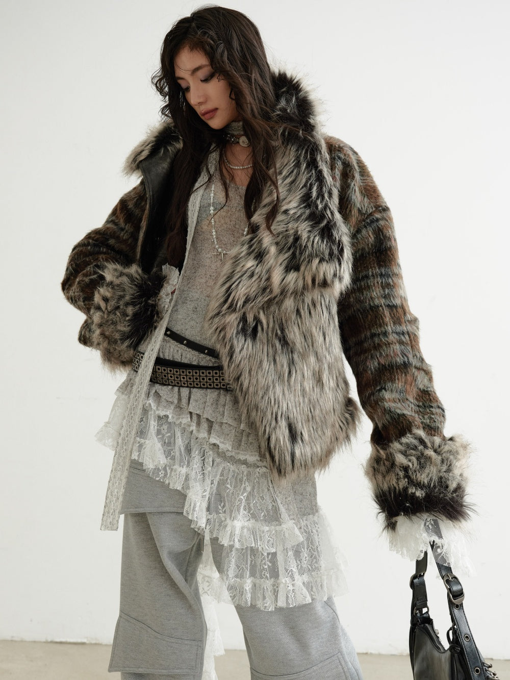 Person wearing a fur coat with a white background