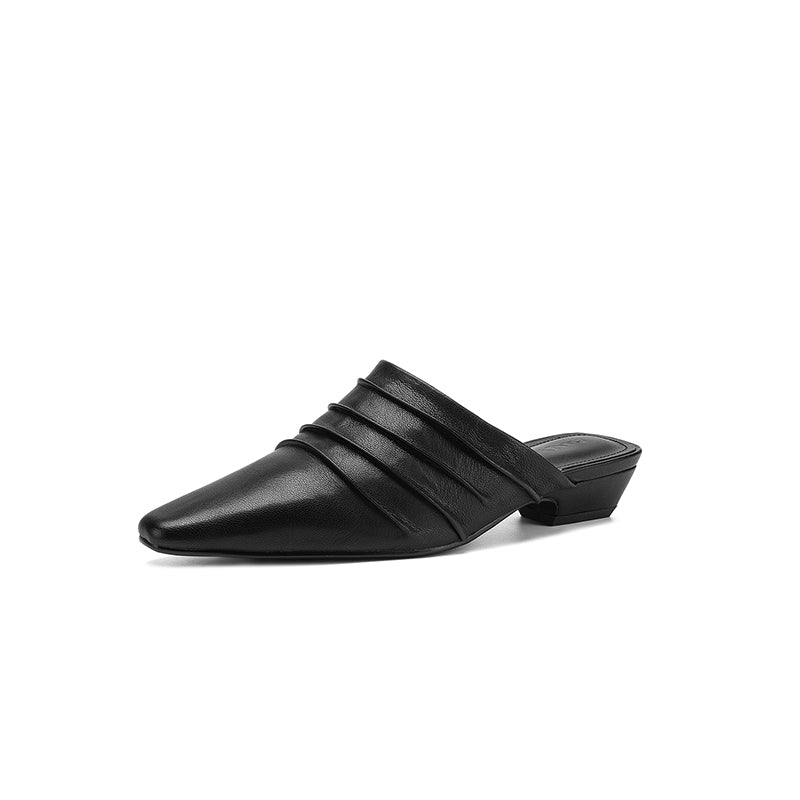 Black pointed-toe mule shoe on a white background