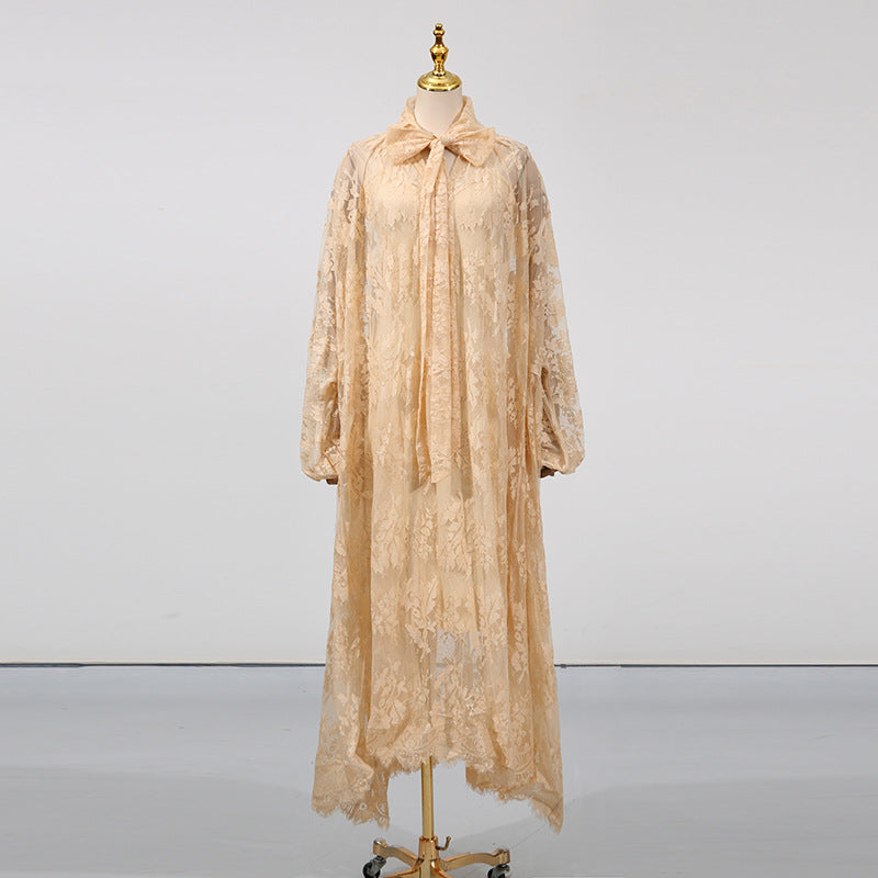 Beige lace dress on a mannequin against a plain background