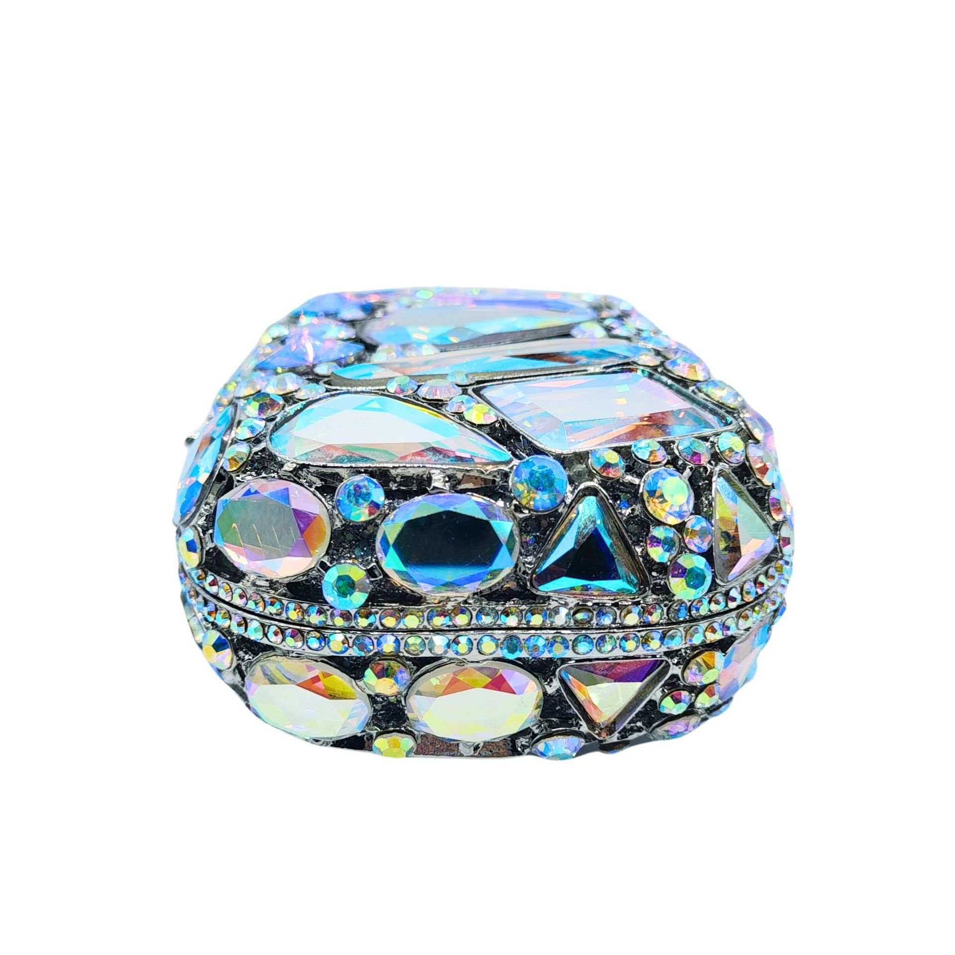 Decorative jewelry box with colorful gemstones on a white background