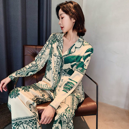 Woman wearing a patterned outfit sitting on a chair against a neutral background