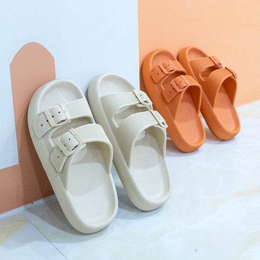 Beige sandals with buckle straps and orange sandals on a light background