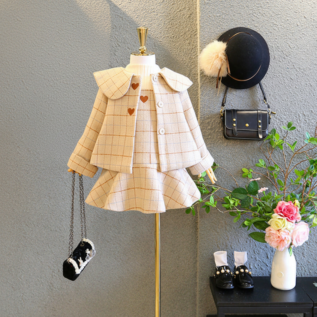 Children's clothing set on a mannequin with accessories in a store setting.