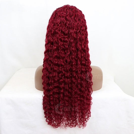 Red curly wig on a mannequin head against a white background