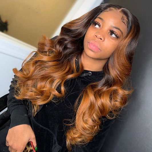 Woman with long, wavy hair styled in a half-up, half-down look.