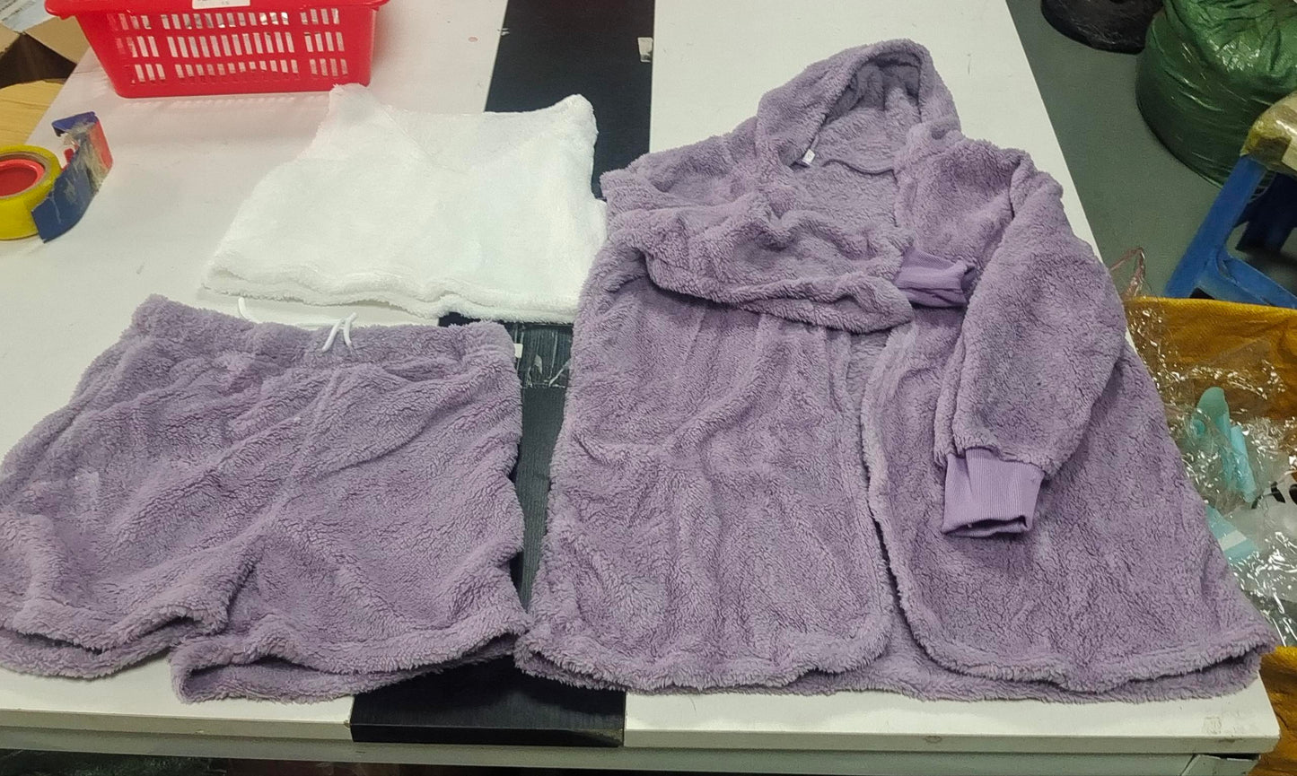 Purple robe and shorts set on a white surface with a red basket in the background.