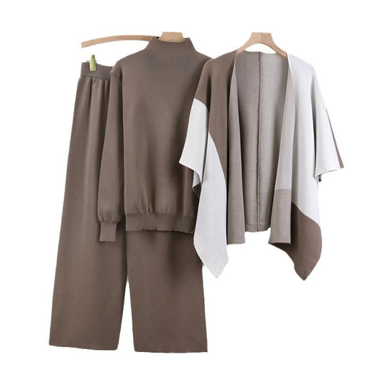 Brown outfit with pants and a sweater on a hanger against a white background