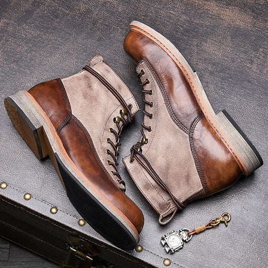 Pair of brown and beige leather boots on a textured surface with a keychain.