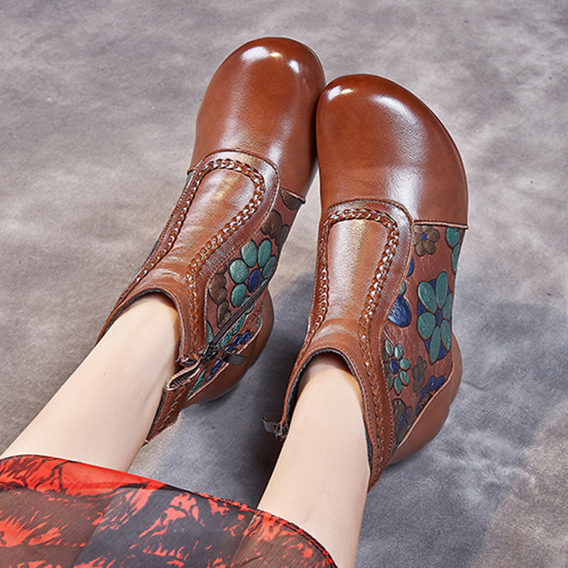 Brown leather shoes with floral patterns on a gray background