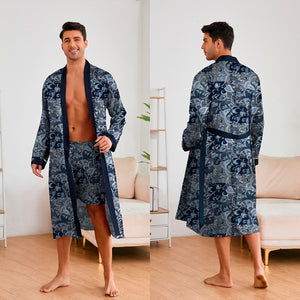 Man wearing a blue floral patterned robe and shorts in a living room setting.