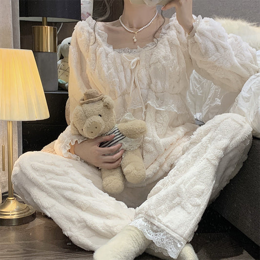 Person wearing a white lace nightgown holding a teddy bear in a cozy room.