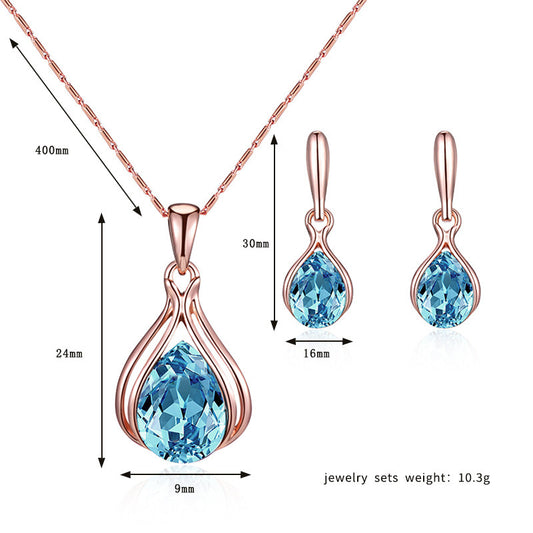Jewelry set with blue gemstones and rose gold accents, including necklace and earrings, with measurements.