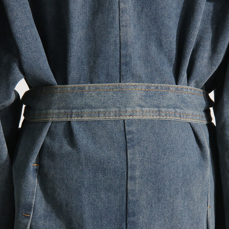Close-up of a blue denim dress with a belt