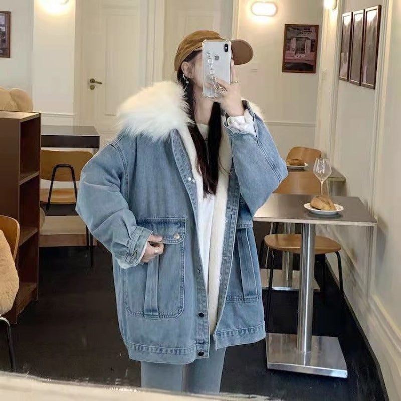 Person wearing a denim jacket with fur hood in a cafe setting