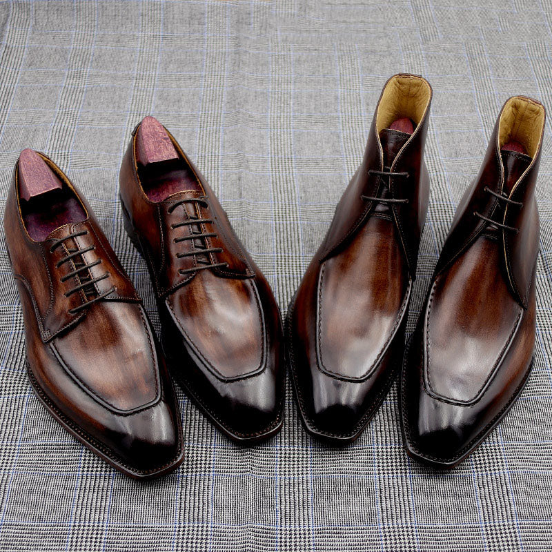 Pair of brown dress shoes on a textured gray surface