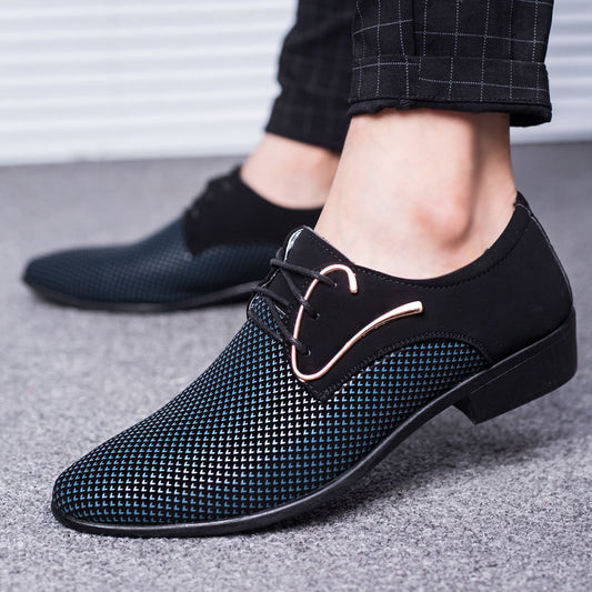 Black mesh dress shoes worn with black pants on a gray floor.