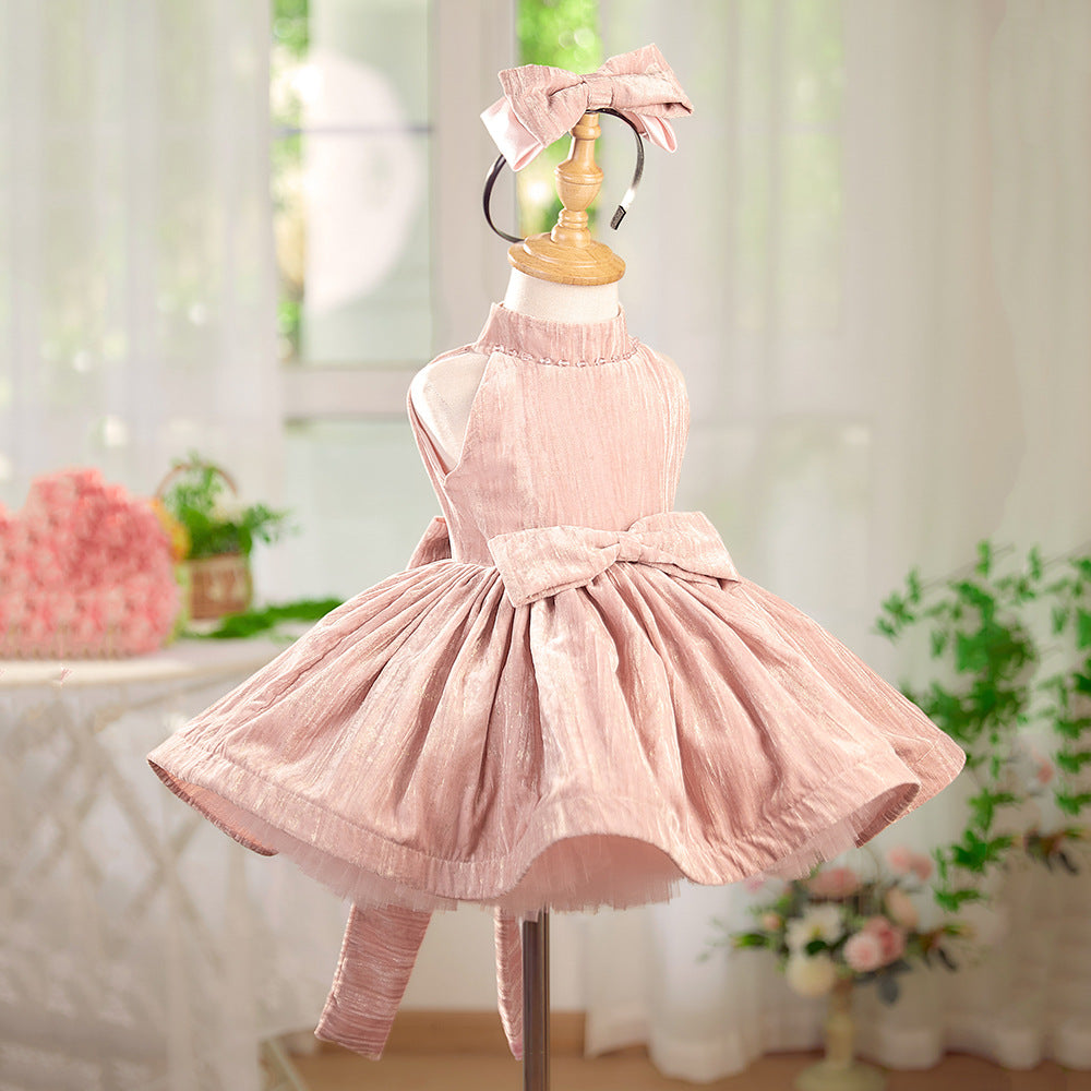 Pink dress on a mannequin with a blurred indoor background