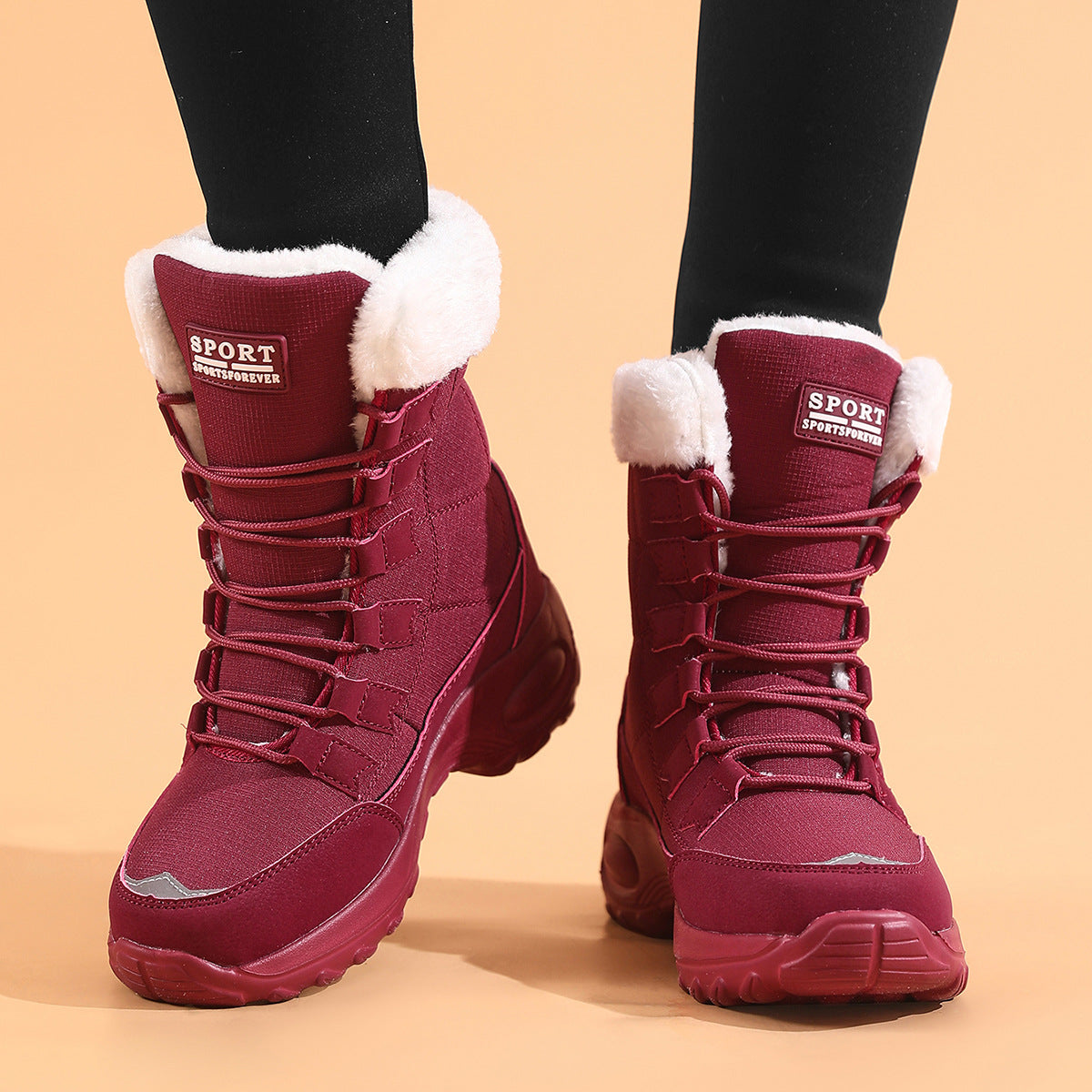Red winter boots with white fur lining on a beige background