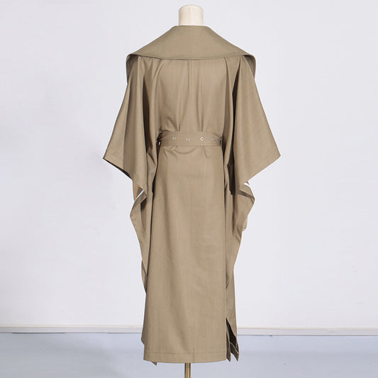 Beige trench coat on a mannequin against a white background