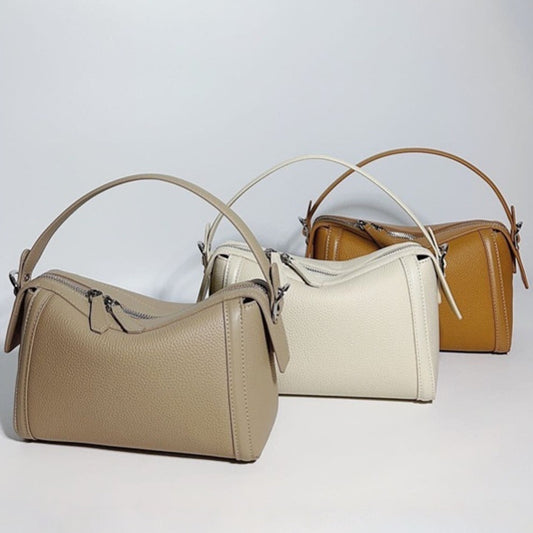 Three handbags in beige, white, and brown on a light gray background