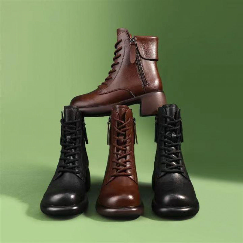 Four pairs of brown and black leather boots on a green background