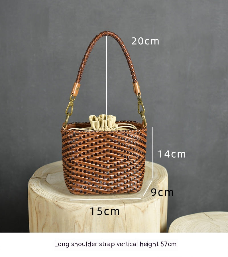 Woven handbag with measurements on a wooden block against a gray background