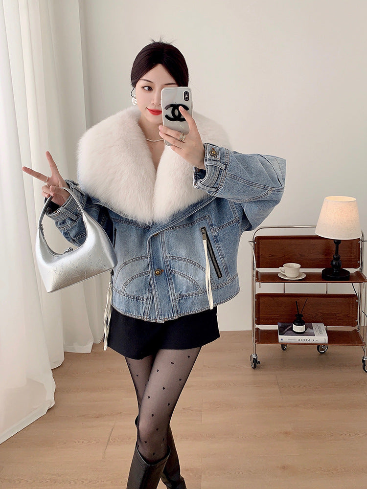 Woman taking a selfie in a room with a lamp and small table.