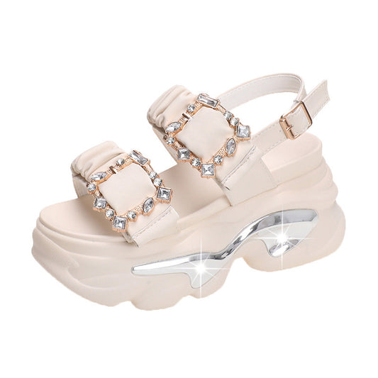 Beige platform sandals with rhinestone embellishments on a white background