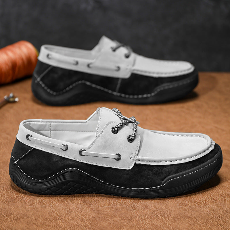 Black and white loafers on a brown surface with a blurred background