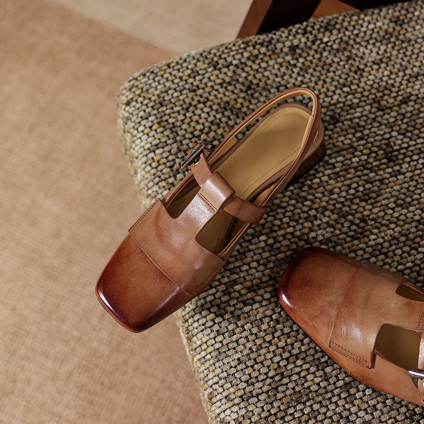 Brown leather shoes on a textured surface