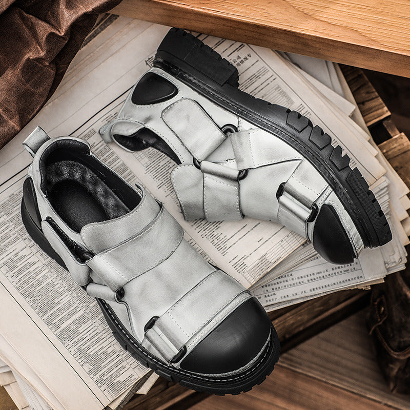 Pair of gray and black shoes on a wooden surface with newspaper underneath